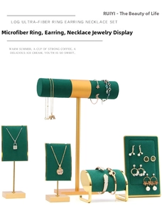 Detail of green microfiber jewelry display set with gold metal bases and necklace stands