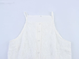 Detail of white sleeveless top with 3D rose floral texture and front button closure
