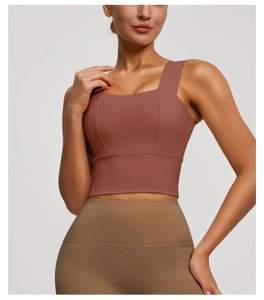 Detail showing the square neck and wide straps of the terracotta sports bra for yoga