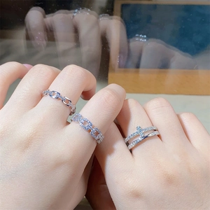 Close-up of stacked S925 sterling silver rings with cubic zirconia on female hand