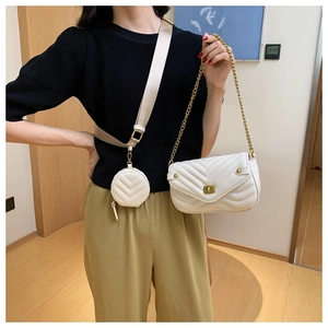 Detail of white chevron quilted bag with gold hardware and extra round coin purse