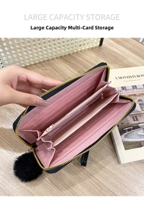 Internal view of women's long zipper wallet showing pink card slots and storage compartments