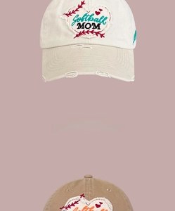 Detail view of heart embroidery with Softball MOM text on distressed baseball caps