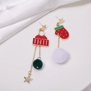 Detailed view of asymmetric Christmas earrings with Santa hat, glove and plush pompoms