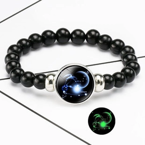 Luminous Sagittarius zodiac bracelet with black leather beads and glowing glass pendant