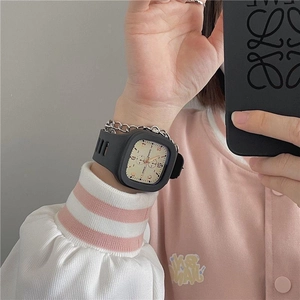 Close-up of a black square digital sports watch with silicone strap on girl's wrist