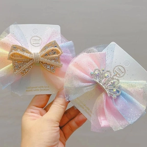 Close-up of rainbow mesh hair clips with rhinestone heart and crown details for girls