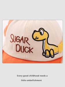 Close-up of cute cartoon dinosaur embroidery on contrast color baby baseball cap