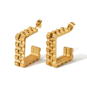 U-shaped gold stainless steel earrings with watch-link texture on a white background