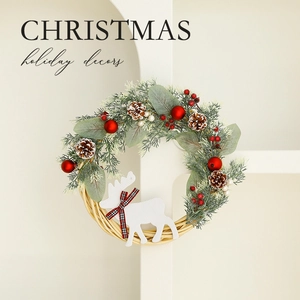 Christmas wreath with pine cones red berries and a white reindeer on a white wall