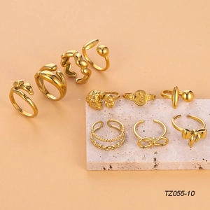 Collection of ten vintage gold stainless steel rings featuring bows and textured designs