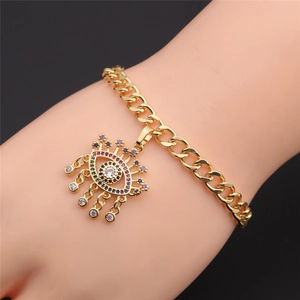 Detailed close-up of a gold Cuban chain bracelet with a colorful zircon Evil Eye pendant