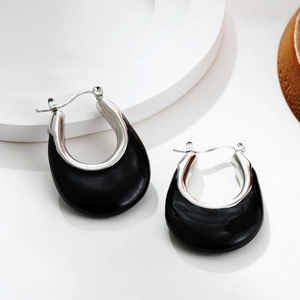 Detailed close-up of U-shaped stainless steel earrings with black enamel finish