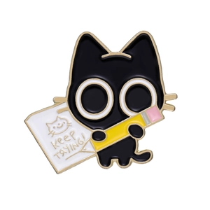 Cute black cat enamel pin with pencil and writing board featuring Keep TRYING! text