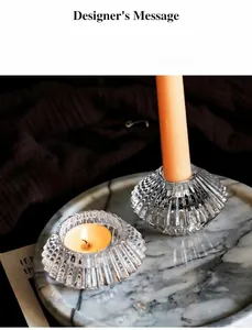 Makro-Detail von eleganten gerippten Glaskerzenhaltern auf einem Marmortablett als Deko