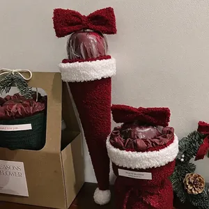 Christmas gift packaging set featuring red sherpa fleece bags and kraft window gift box