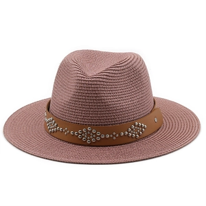 Detail of dusty pink straw fedora hat featuring a brown leather band with silver studs