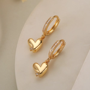Exquisite gold-plated heart drop earrings with sparkling cubic zirconia on beige surface