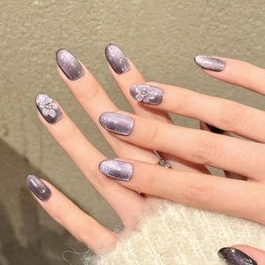 Luxury handmade purple glitter cat-eye press-on nails featuring 3D floral accents.