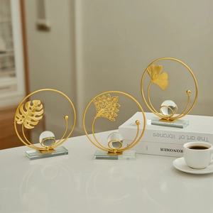 Golden metal leaf statues with crystal ball and glass base for luxury table decoration