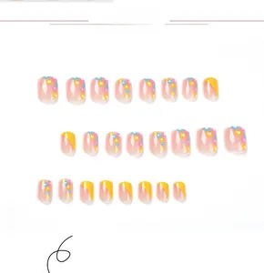 Détails de 24 faux ongles avec pointes françaises jaunes et motifs de fleurs