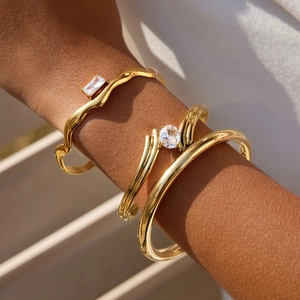 Gold plated titanium steel open cuff bracelet set with zircon stones on female wrist
