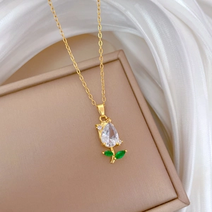 Luxurious gold tulip necklace with zircon crystals on beige box with white silk fabric