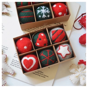 Macro detail of handmade wool felt Christmas ornaments in a kraft gift box set