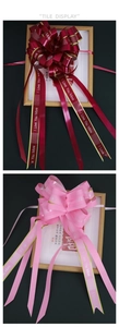 Detail of red and pink gift ribbons with gold edges and I Love You More lettering