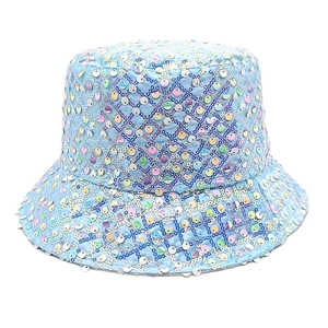 Close-up of light blue bucket hat with iridescent sequins and quilted diamond pattern