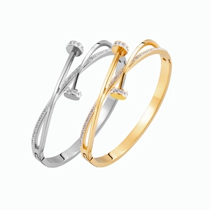 Detailed close-up of crisscross nail bracelets with sparkling pavé crystal accents