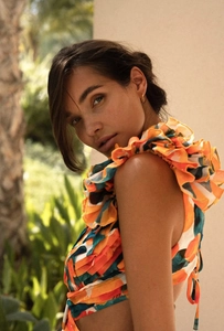 Close-up of vibrant floral backless dress with ruffle tiered details and hollow out design