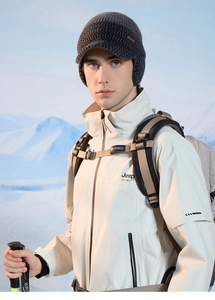 Detailed close-up of dark grey knitted earflap hat with brim for winter outdoor activities