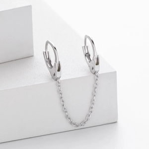 Detail of S925 sterling silver double hoop earrings with link chain on a white display