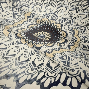 Detailed macro view of bohemian mandala tapestry fabric texture and navy floral patterns