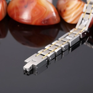 Macro shot of two-tone stainless steel bracelet with square links and inlaid crystals
