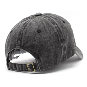 Detail view of washed cotton baseball cap with adjustable copper buckle and vintage texture