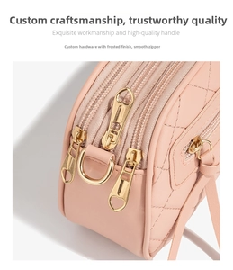Detail of pink quilted PU leather crossbody bag with three golden heart zipper pulls