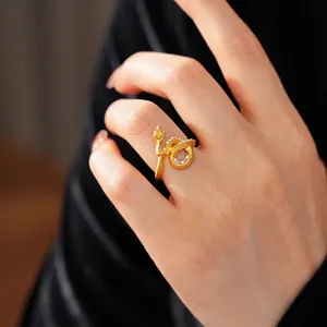 Gold-plated snake-shaped wrap ring with sparkling zircon inlays shown on finger