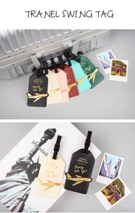 Flat lay of colorful faux leather travel luggage tags with gold airplane patterns on a suitcase