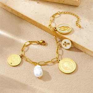 Golden necklace with portrait pendant, hollow cross and baroque pearl on beige stone