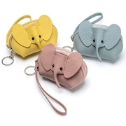 Detailed view of three cute elephant leather coin purses in yellow, blue and pink colors