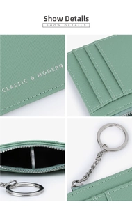 Detail view of mint green Saffiano leather wallet with card slots and silver keychain