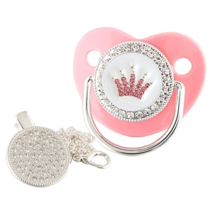 Detail of pink baby pacifier with rhinestone crown design and matching silver chain clip