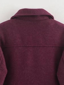 Detailed close-up of dark purple wool jacket collar showing fine texture and stitching