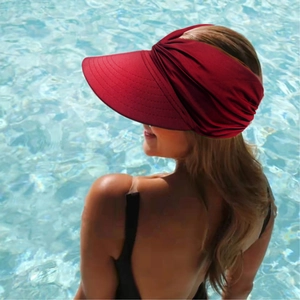 Close-up of a burgundy women's sun visor with pleated headband and wide brim detail