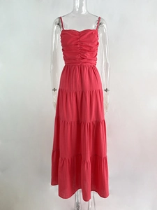 Macro detail of tiered rose red summer dress featuring pleated bust and thin straps