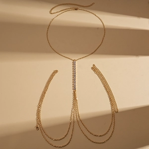 Detail of golden geometric body chain with sparkling rhinestones and adjustable links