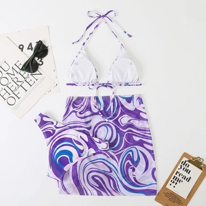 Detailed flat lay of a three-piece marble print bikini set with matching beach sarong