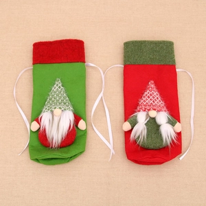 Christmas gnome wine bottle covers in red and green felt with knitted hats and drawstrings